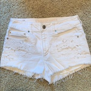 White jean shorts with flower detail on pockets